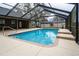 An inviting in-ground pool in a screened enclosure features tiled steps and a clean, bright deck area at 4604 Se 33Rd Pl, Ocala, FL 34480