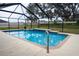 Beautiful in-ground screened pool with tiled accents and handrail that offers a serene outdoor retreat at 4604 Se 33Rd Pl, Ocala, FL 34480