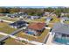 An aerial view of the house displays the large screened-in pool and fenced yard at 5094 Se 89Th St, Ocala, FL 34480