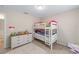 Bedroom featuring a bunk bed, chest of drawers, and neutral decor at 5094 Se 89Th St, Ocala, FL 34480