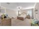 Bright main bedroom with a ceiling fan, carpeted floor, and natural light at 5094 Se 89Th St, Ocala, FL 34480