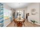 Bright dining room with wood floors, table and chairs, and sliding door access at 5094 Se 89Th St, Ocala, FL 34480