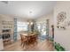 Sunlit dining room with wood table, chairs, and sliding doors to the patio at 5094 Se 89Th St, Ocala, FL 34480