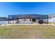 The screened-in pool features a spacious deck for lounging and outdoor entertaining at 5094 Se 89Th St, Ocala, FL 34480