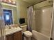 Bathroom featuring a tub-shower, single sink vanity, mirror, and green walls at 5155 Sw 39Th St, Ocala, FL 34474