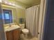 Cozy bathroom with toilet, vanity sink, and shower with curtain at 5155 Sw 39Th St, Ocala, FL 34474