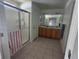 Well-lit bathroom with a double vanity, mirrored cabinets, and a glass-enclosed shower at 5155 Sw 39Th St, Ocala, FL 34474