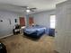 Cozy bedroom with carpet, a ceiling fan, a closet, and two windows with natural light at 5155 Sw 39Th St, Ocala, FL 34474