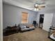 Bedroom featuring carpeted floors, gray walls, a ceiling fan, a window with blinds and an open closet at 5155 Sw 39Th St, Ocala, FL 34474