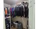 Walk-in closet with metal shelving, hanging clothes, and some items on the floor at 5155 Sw 39Th St, Ocala, FL 34474