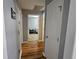 Hallway with wood floors leading to carpeted rooms, providing a smooth transition between living spaces at 5155 Sw 39Th St, Ocala, FL 34474