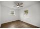 Bedroom featuring wood floors, ceiling fan, and windows providing natural light at 6 Cherry Drive Ln, Ocala, FL 34472