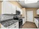 Modern kitchen featuring white cabinets, stainless steel appliances, and sleek countertops at 6 Cherry Drive Ln, Ocala, FL 34472