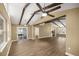 Spacious living area featuring exposed beams, ceiling fans, and wood-look flooring at 6 Cherry Drive Ln, Ocala, FL 34472