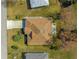 An aerial view of the roof shows the mature landscaping, patio area, and attached two-car garage at 6188 Sw 84Th St, Ocala, FL 34476