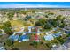 A high, aerial view of a residential neighborhood with green spaces, mature trees, and a water tower in the distance at 6188 Sw 84Th St, Ocala, FL 34476