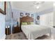 Bedroom with a large carved headboard, soft lighting, and blue accents at 6188 Sw 84Th St, Ocala, FL 34476