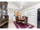 Cozy dining area with a wood table, set on a rug, and open to the kitchen at 6188 Sw 84Th St, Ocala, FL 34476