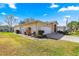 Exterior view of a single-story home with an attached two-car garage and manicured lawn at 6188 Sw 84Th St, Ocala, FL 34476