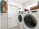 Functional laundry area with a modern washing machine and dryer set against a white wall at 6188 Sw 84Th St, Ocala, FL 34476