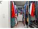 Walk-in closet with a center organizer and shelves full of clothes and shoes at 6188 Sw 84Th St, Ocala, FL 34476