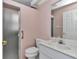 Bathroom with shower, pink walls, white marble vanity, and white toilet at 6793 Sw 111Th Loop, Ocala, FL 34476