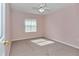 Bedroom with carpet flooring, ceiling fan, and a window providing natural light at 6793 Sw 111Th Loop, Ocala, FL 34476