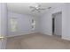 Bedroom with neutral carpet, light purple walls, and window with blinds at 6793 Sw 111Th Loop, Ocala, FL 34476