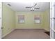 Bedroom with neutral carpet, light green walls, and a ceiling fan with lights at 6793 Sw 111Th Loop, Ocala, FL 34476