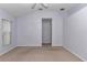 Bedroom with neutral carpet, light purple walls, and a view into the hall at 6793 Sw 111Th Loop, Ocala, FL 34476