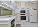 Bright kitchen featuring white cabinets, modern appliances, and white tile floors for a clean aesthetic at 6793 Sw 111Th Loop, Ocala, FL 34476