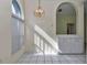 A bright nook space with white cabinetry, tile flooring, and a window with decorative lighting fixture above at 6793 Sw 111Th Loop, Ocala, FL 34476