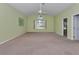 Bright living room with neutral carpet, green walls, and a large window at 6793 Sw 111Th Loop, Ocala, FL 34476