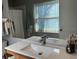 Modern bathroom with a single wooden vanity and a step in shower at 8045 Sw 115Th Loop, Ocala, FL 34481