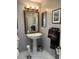 Traditional bathroom featuring a pedestal sink, decorative mirror and classic finishes at 8045 Sw 115Th Loop, Ocala, FL 34481