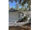 Attached two-car garage and a tidy landscape design along the side of the house at 8045 Sw 115Th Loop, Ocala, FL 34481