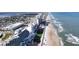 Panoramic aerial view of a beachfront community with high-rise buildings along the sandy shore at 840 Center Ave # 98, Holly Hill, FL 32117