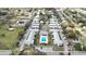 Aerial view of a residential neighborhood featuring well-maintained buildings and a central swimming pool at 840 Center Ave # 98, Holly Hill, FL 32117