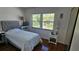 Bedroom featuring wood floors, a tufted headboard, and natural light from the window at 840 Center Ave # 98, Holly Hill, FL 32117