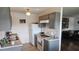 Galley-style kitchen featuring gray cabinets, a white refrigerator, and laminate flooring at 840 Center Ave # 98, Holly Hill, FL 32117