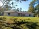 Front view of a home featuring a well-manicured lawn and a classic architectural style at 8498 Sw 129Th Terrace Rd, Dunnellon, FL 34431