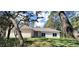 Image of the front exterior of a home showcasing its well-manicured lawn and classic architectural style at 8498 Sw 129Th Terrace Rd, Dunnellon, FL 34431