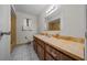 Bathroom featuring a long vanity with a white sink, with a toilet, window and bathtub in view at 8973 Sw 104Th Ln, Ocala, FL 34481