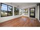 Bright sunroom with many windows looking out to the front yard and wood-look flooring at 8973 Sw 104Th Ln, Ocala, FL 34481