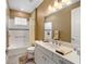 Well-lit bathroom featuring white cabinets, a shower/tub combo, and neutral decor at 9276 Sw 89Th St Rd, Ocala, FL 34481