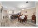 Inviting dining area blends seamlessly with a modern kitchen featuring white cabinetry and a spacious island with bar seating at 9276 Sw 89Th St Rd, Ocala, FL 34481