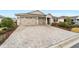 Wide, paved driveway leading to a well-maintained home with a three-car garage at 9276 Sw 89Th St Rd, Ocala, FL 34481