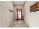 Elegant entryway with tiled flooring, a decorative vase, and a stylish front door at 9276 Sw 89Th St Rd, Ocala, FL 34481