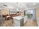 Open kitchen layout featuring an island with seating, stainless steel appliances, and views of the outdoor patio at 9276 Sw 89Th St Rd, Ocala, FL 34481