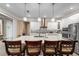 Spacious kitchen island with granite countertops and barstools, perfect for casual dining and entertaining guests at 9276 Sw 89Th St Rd, Ocala, FL 34481